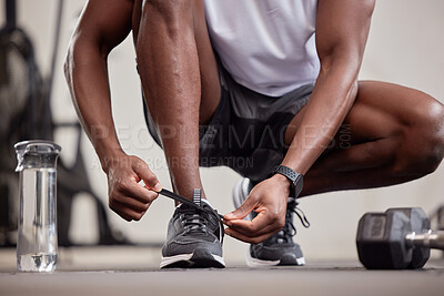 Buy stock photo Hands, fitness and tie shoes in gym to start workout, training or exercise practice. Sports, health and black man or athlete tying sneakers to get ready for exercising, running or cardio for wellness
