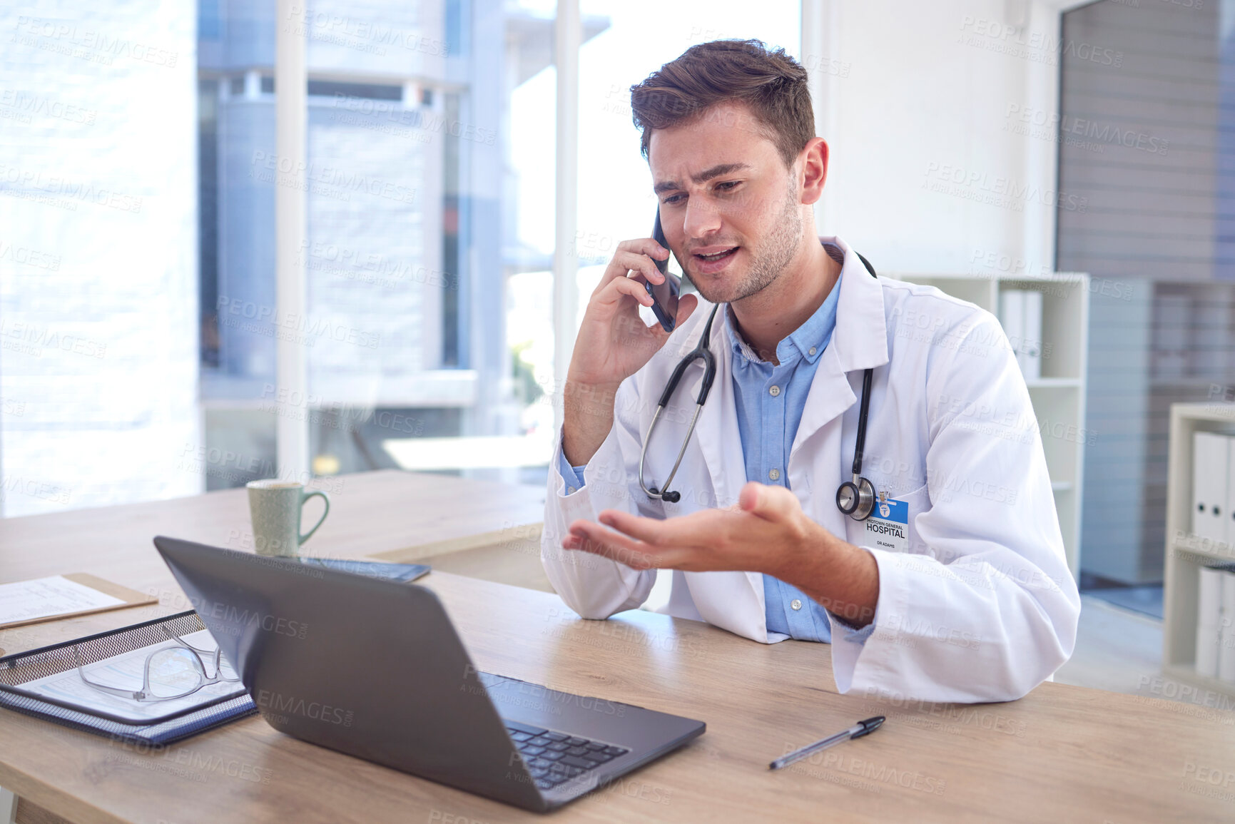 Buy stock photo Man, doctor and phone call with laptop in Telehealth for healthcare consulting, advice or help at office desk. Male medical professional on smartphone by computer explaining medicare or diagnosis