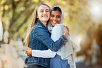 Hug, portrait and interracial and lesbian couple in the city with affection, happiness and freedom. Happy, smile and diverse women friends hugging with love, care and together in town for joy
