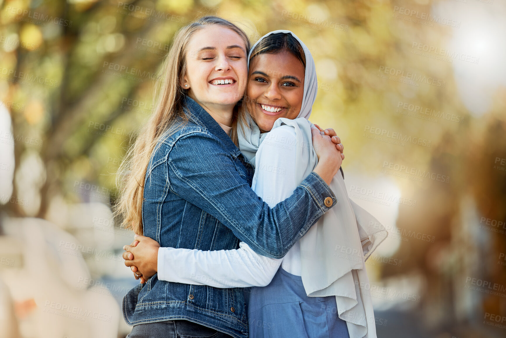 Buy stock photo Hug, portrait and interracial and lesbian couple in the city with affection, happiness and freedom. Happy, smile and diverse women friends hugging with love, care and together in town for joy