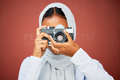 Buy stock photo Photography, muslim woman taking picture with camera and mockup with smile isolated on red background. Creative professional lifestyle photographer in hijab, hobby or career taking photo in studio.