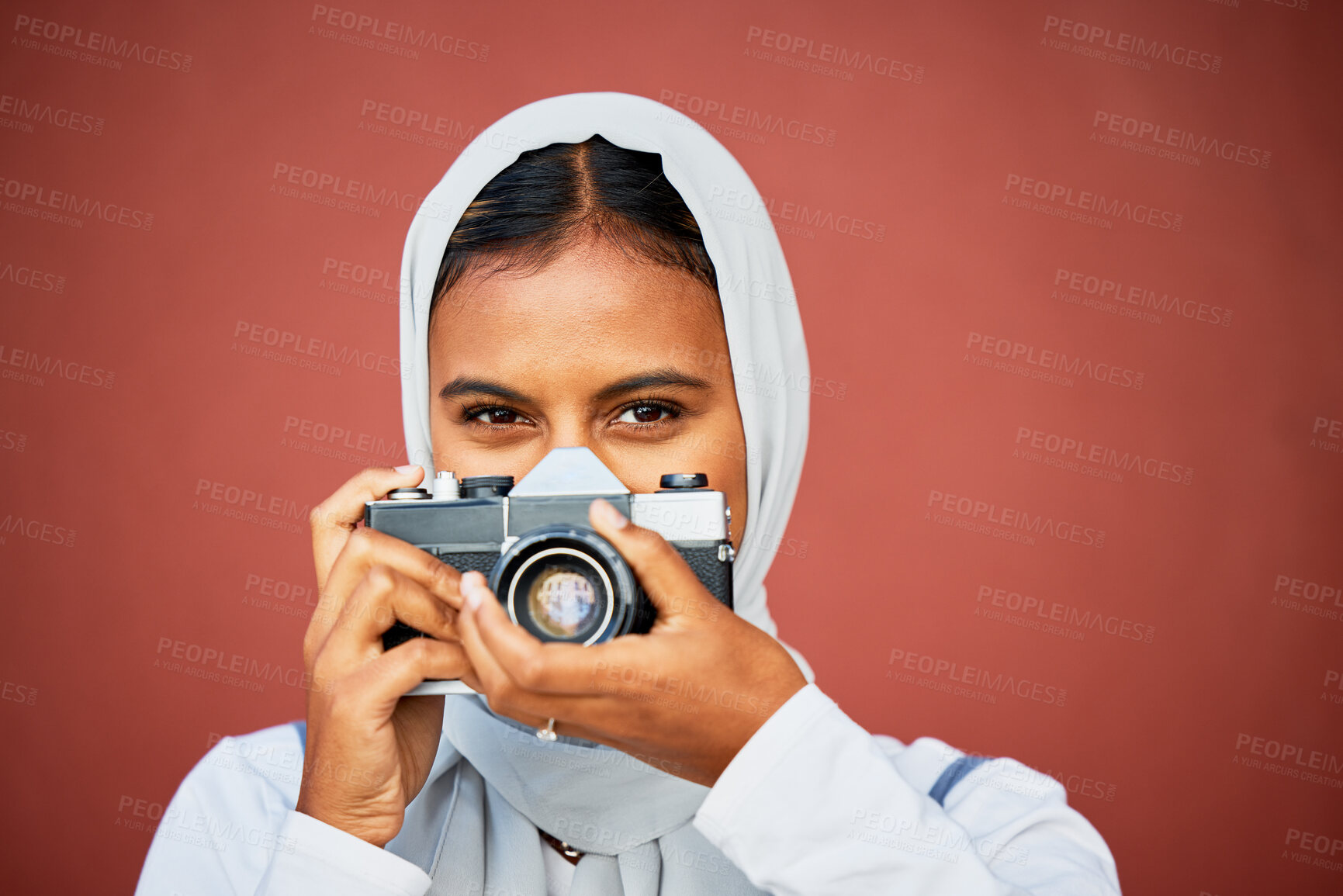 Buy stock photo Photography, portrait of muslim woman holding camera and mockup with smile isolated on red background. Creative professional lifestyle photographer in hijab, hobby or career taking photo in studio.
