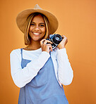 Smile, camera and photographer with portrait of woman for creative, retro and shooting photos. Fashion, happiness and vintage with girl and photography for picture, lens and focus in wall background