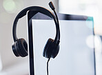 Headset, computer and mockup screen in call center for desktop support, communication or telemarketing at office. Headphones, equipment or contact us technology and tools on monitor display at work