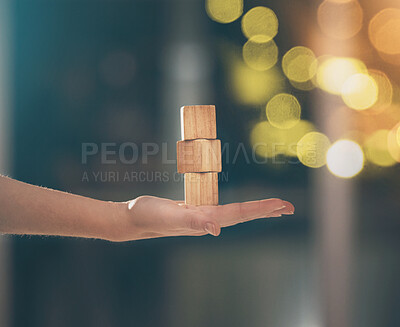 Buy stock photo Hand, building blocks and balance with a business woman holding wood for growth on a blurred background. Investment, portfolio and stack with the foundation of a company built on financial stability