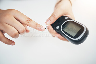 Buy stock photo Diabetes, hands of black woman and blood test strip on finger, healthcare and medicine in home. Health, innovation and technology, diabetic person with digital hand glucometer checking glucose level.