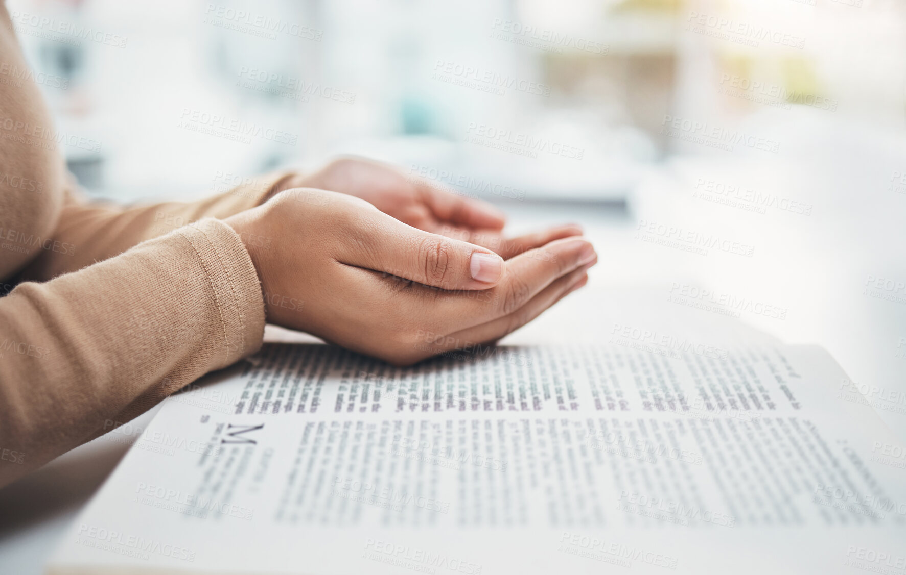 Buy stock photo Religion, prayer and bible with hands of woman for worship, support and Christian faith. Believe, spirituality and God with girl praying over catholic holy text for wellness, respect and hope 