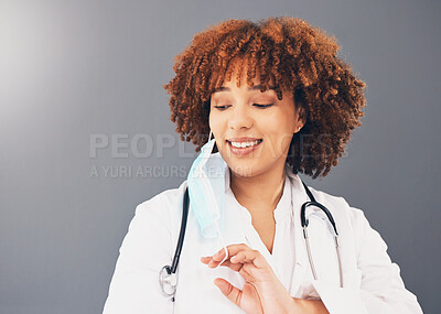Buy stock photo Black woman, doctor and Covid, remove face mask and health, end of pandemic and protection on studio background. Face, smile and mockup with healthcare, safety from virus and positivity with female