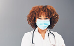 Portrait, mockup and healthcare with black woman, mask and safety regulations against grey studio background.   Face cover, Jamaican female doctor and medical professional with stethoscope and trust