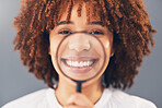 Happy, portrait and black woman with magnifying glass in a studio for a investigation or research. Happiness, smile and portrait of a young African female model with a zoom lens by a gray background.