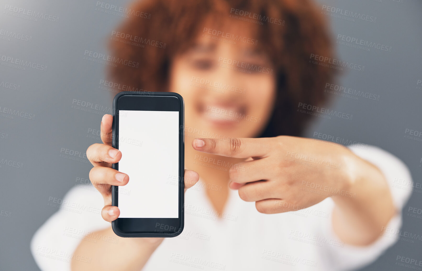 Buy stock photo Mockup, blank phone screen and hand pointing to digital marketing, advertisement and web message. Discount, sale and promotion deal mock up of a black woman in a studio with blurred background