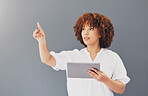 Business, pointing and black woman with tablet, cyber security and focus against a grey studio background. African American female, web designer and leader with device, connection and technology