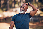 Black man, exercise and stretching for fitness warm up before running outdoor for motivation. Senior person with smile in nature forest for muscle workout and training for cardio, health and wellness