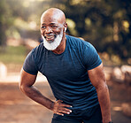 Running, break and black man breathing for fitness, exercise and workout in nature, park or garden. Senior male, sports and rest with smile, motivation and healthy cardio wellness outdoors with music