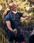 Man, hiking and watch on adventure in nature for trekking, fitness and cardio exercise. Senior black person with backpack walking outdoor with smartwatch for gps travel time, health and wellness app