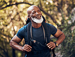 Nature, backpack and senior black man hiking in a forest for exercise, health and wellness. Sports, athlete and happy elderly African male hiker in retirement trekking in the woods on adventure trail
