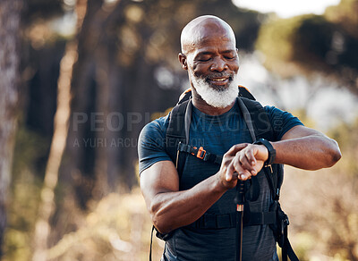 Buy stock photo Hiking, man and watch for time in nature forest trekking for fitness and cardio exercise. Senior black person smile while walking outdoor with backpack and smartwatch for travel, health and wellness