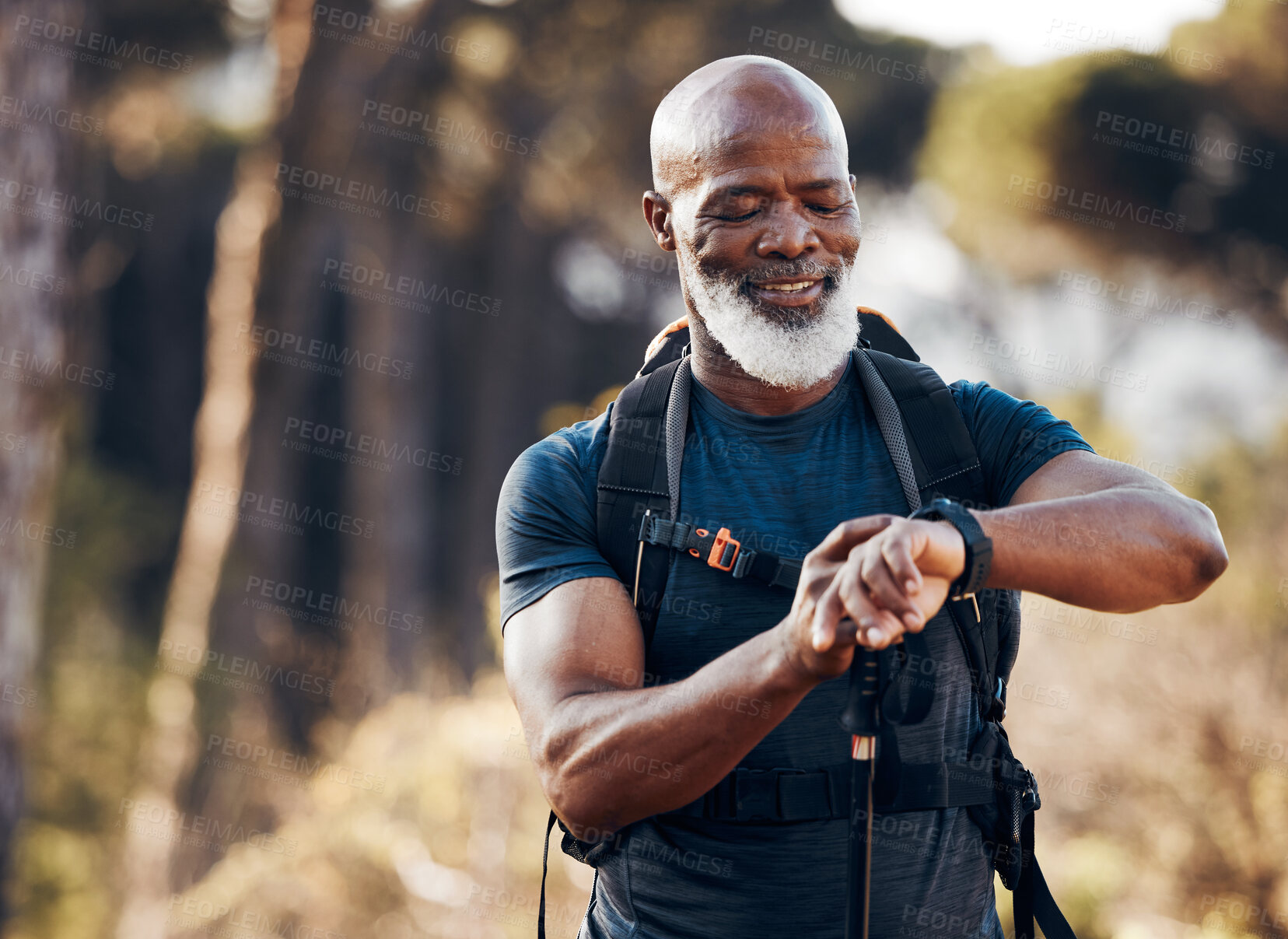 Buy stock photo Hiking, man and watch for time in nature forest trekking for fitness and cardio exercise. Senior black person smile while walking outdoor with backpack and smartwatch for travel, health and wellness