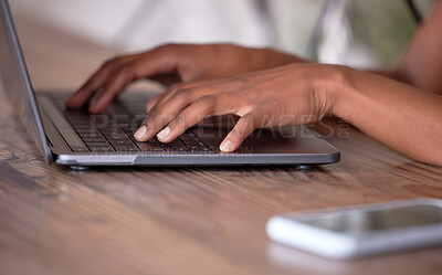 Buy stock photo Hands, laptop and typing on wooden table for communication, email or social media. Hand of African American freelancer working remote on computer keyboard for research, browsing or networking on desk