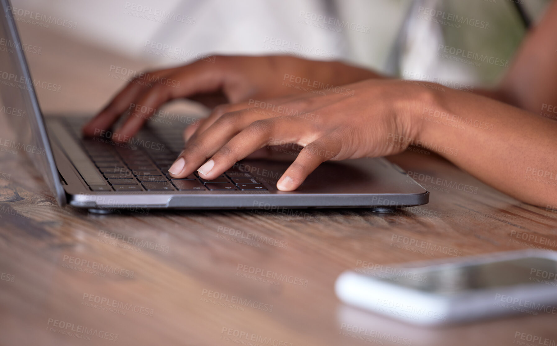 Buy stock photo Hands, laptop and typing on wooden table for communication, email or social media. Hand of African American freelancer working remote on computer keyboard for research, browsing or networking on desk