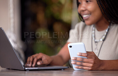 Buy stock photo Black woman, phone and laptop in remote work at cafe for communication, social media or chatting. Hands of happy African American female freelancer with smile working on computer and smartphone