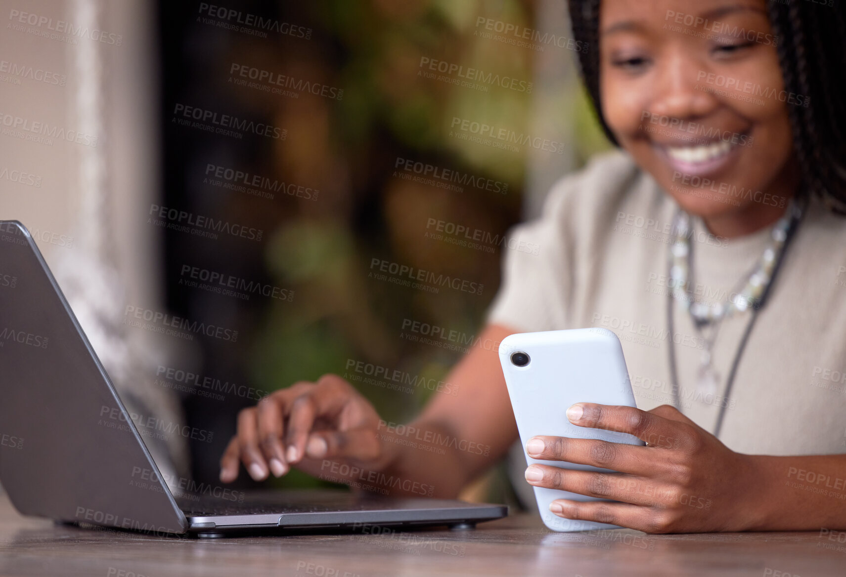 Buy stock photo Black woman, phone and laptop in remote work for communication, social media or chatting at cafe. Hands of happy African American female freelancer with smile working on computer and smartphone