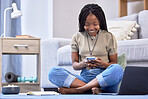 Black woman, student and phone with smile for social media, chatting or texting sitting on floor in living room. Happy African American female learner smiling on mobile smartphone for communication