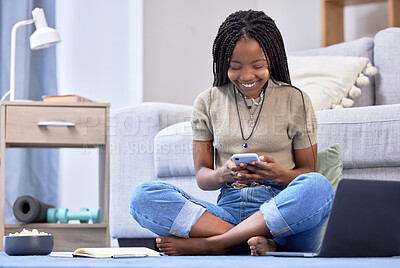 Buy stock photo Black woman, student and phone with smile for social media, chatting or texting sitting on floor in living room. Happy African American female learner smiling on mobile smartphone for communication