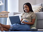 Relax, black woman on floor and laptop for movies, happiness and girl in living room. African American female, lady and device for streaming shows, funny videos or search internet in lounge on ground
