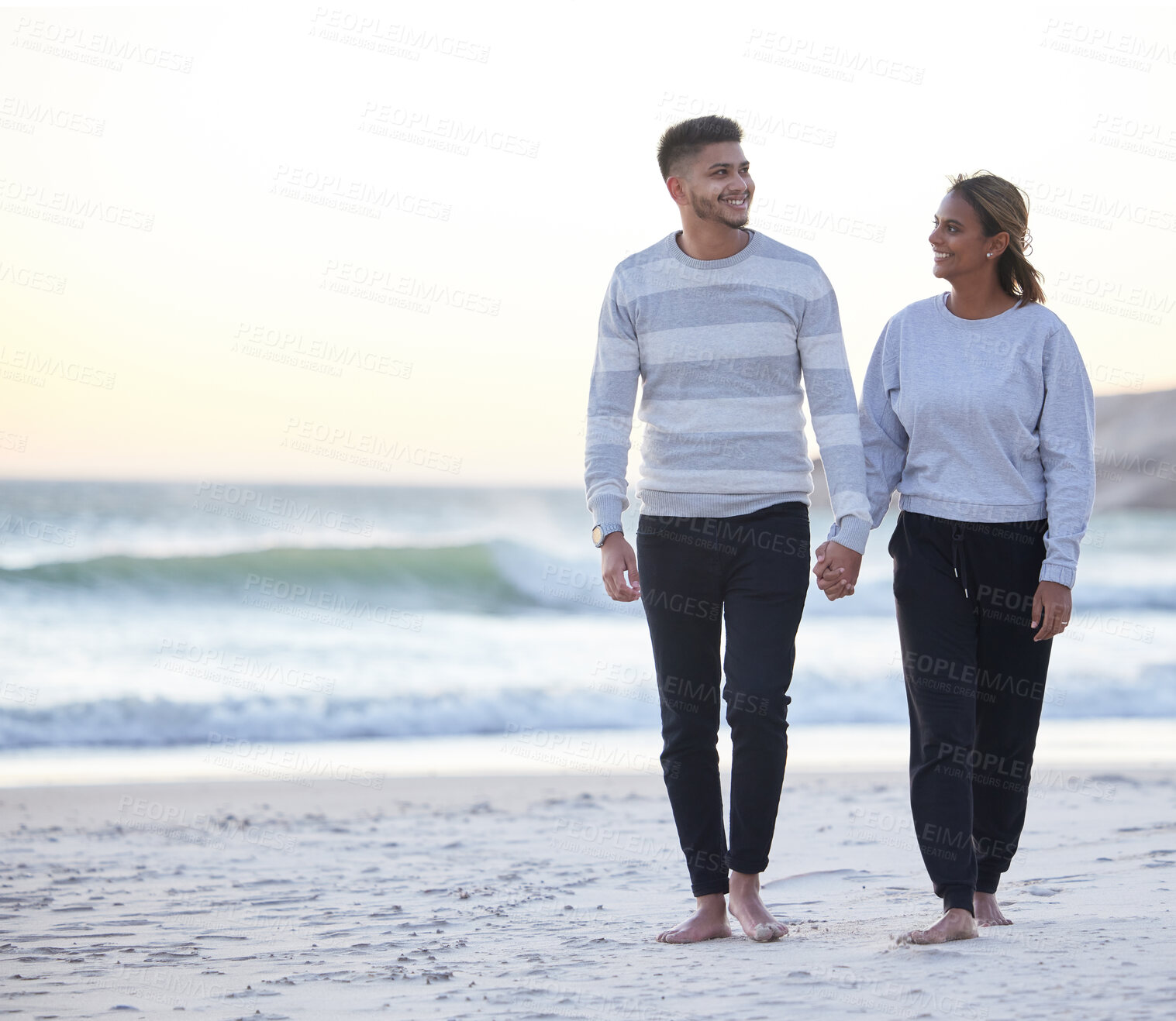 Buy stock photo Love, relax and holding hands with couple at beach for travel, happy and bonding with mockup. Vacation, support and romance with man and woman walking at sunset for happiness, holiday or weekend trip