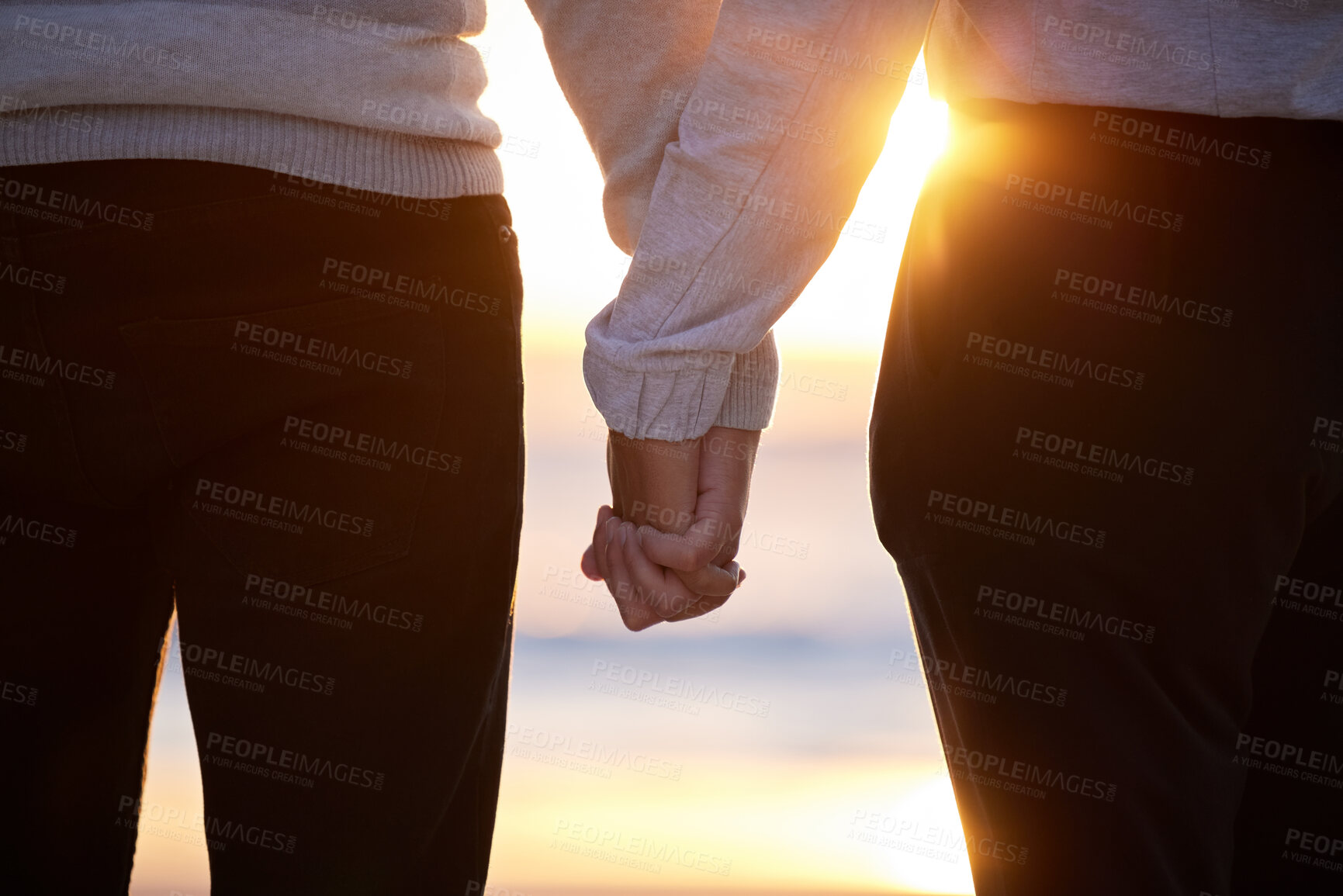 Buy stock photo Beach, couple and holding hands at sunset for love and trust or commitment and support on vacation. Hand of man and woman together on holiday at sea to relax, travel and connect in nature with care