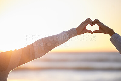 Buy stock photo Couple, heart and hands at sunset for love at beach, date and holiday mockup together. Man, woman and finger shape for care in relationship, support and trust at ocean, hope and freedom of emoji sign