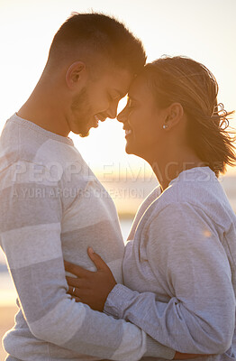 Buy stock photo Couple, sunset and forehead touch for love, outdoor beach date and happy holiday. Young man, woman and face of relationship at ocean for freedom, support and relax with trust, peace and smile of care