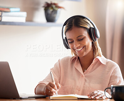 Buy stock photo Headphones, student and woman writing on book in home, studying and research. Distance learning, education scholarship and smile of happy female with notebook while streaming podcast, radio or music.