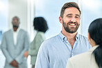 Happy, meeting and business man with colleague in the office with a positive mindset talking during break. Employee, worker and professional person smile at the workplace satisfied with company