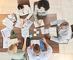 Teamwork, collaboration and business people with research data and work notes. Office meeting, marketing planning and staff from above on conference room table with web analytics agenda and schedule