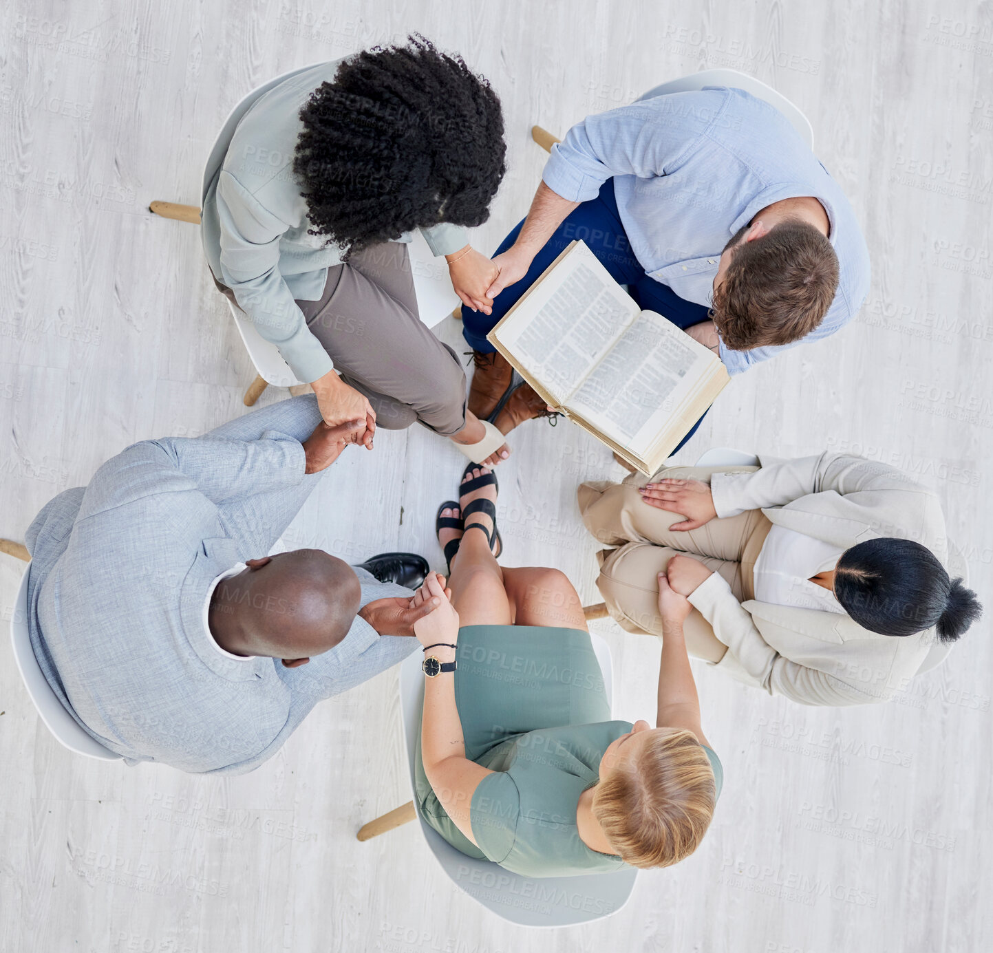 Buy stock photo Prayer group, circle nd people holding hands above for religion support, faith and spiritual connection. Bible study, holy book and praying with Christian community in trust, counseling and worship