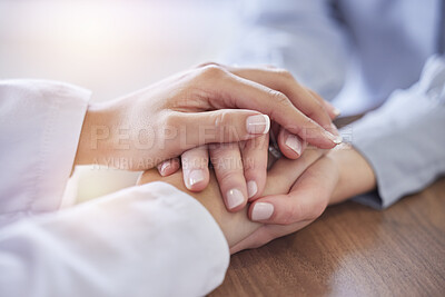 Buy stock photo Holding hands, doctor and patient at desk for comfort, talking and communication for bad news, mental health or support. Therapist woman, cancer and together for empathy, care or wellness in hospital