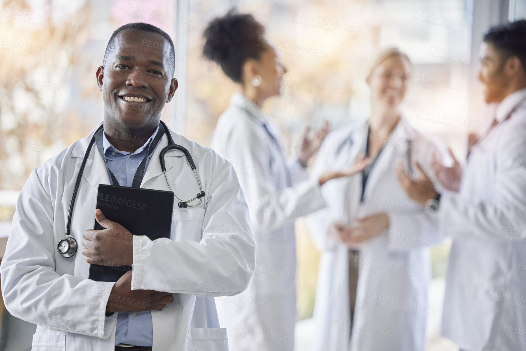 Buy stock photo Black man, doctor portrait and tablet with medical team in hospital ready for healthcare work. Wellness, health and medic employee in a clinic feeling happiness and success with blurred background