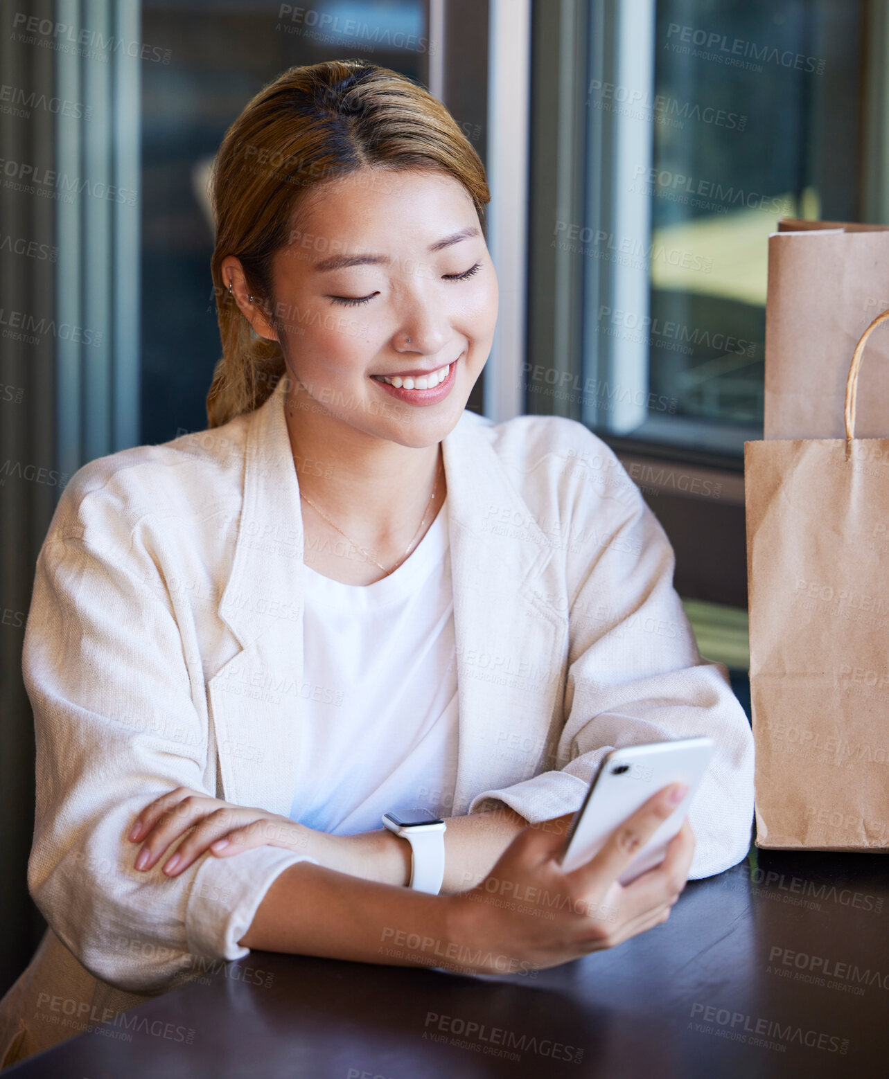 Buy stock photo Phone, shopping and Asian woman in restaurant with smile for product deal, ecommerce and sale. Technology, fashion and happy girl on smartphone for text message, social media and website in mall