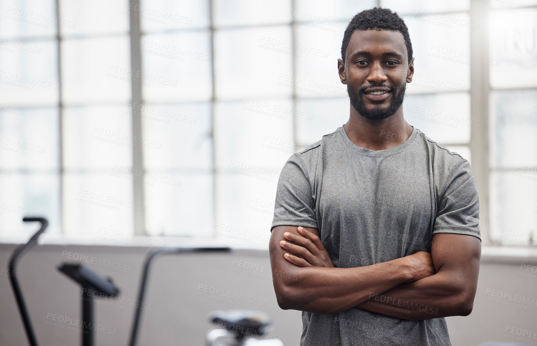 Buy stock photo Happy black man smile in gym with arms crossed for training, exercise or workout in Nigeria. Portrait of strong bodybuilder, personal trainer and male in fitness club for coaching, sports or wellness