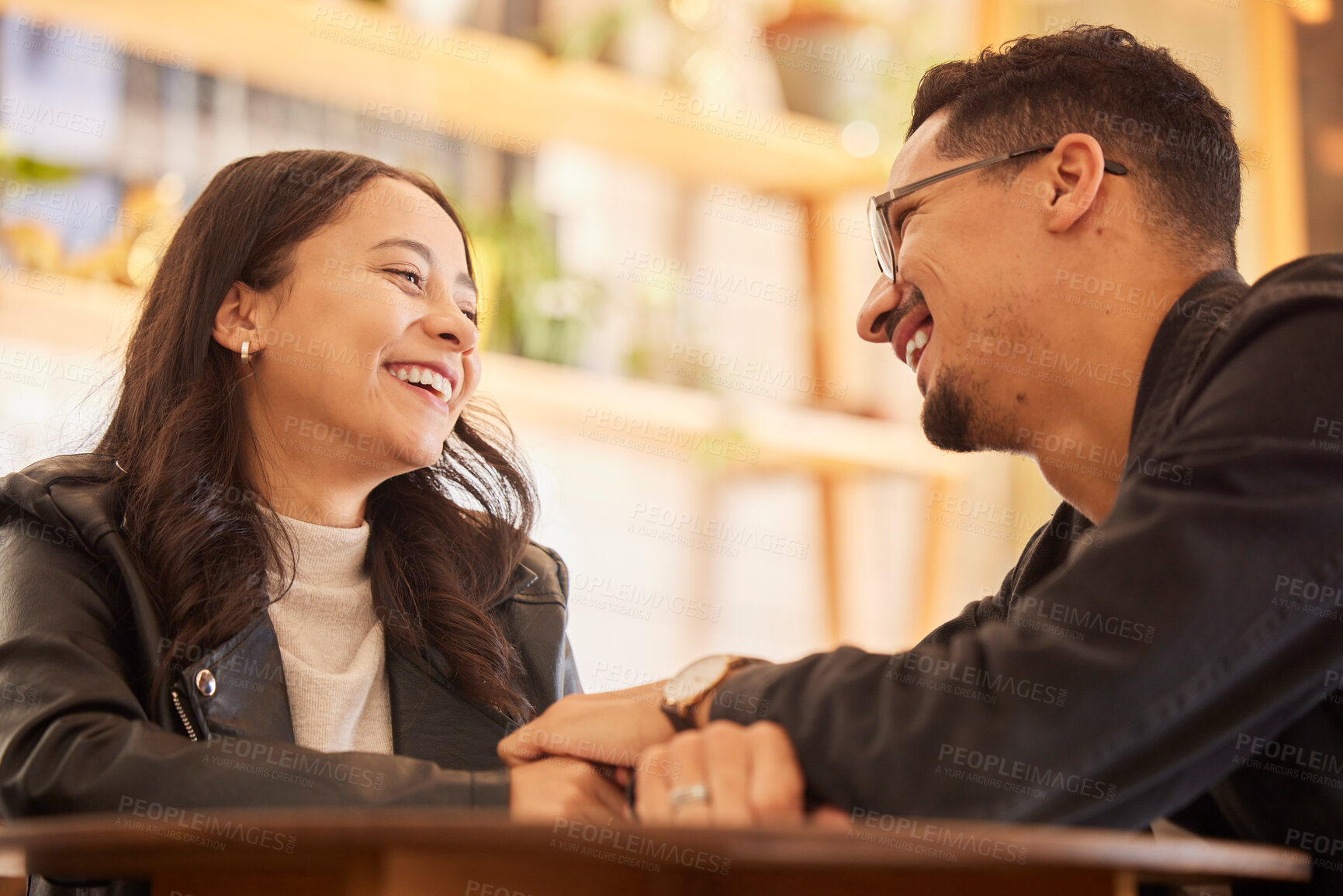 Buy stock photo Couple, date and man happy with woman in a restaurant, coffee shop or cafe together bonding and funny conversation. Flirting, love and boyfriend relax with girlfriend  on weekend break