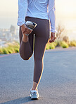 Fitness, leg and stretching by woman in road for running, training and exercise at sunset, body and warm up. Runner, stretch and rear view of girl at sunrise for cardio, marathon or practice run