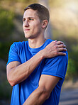 Injury, sport and man holding an arm with pain during running, exercise and strain from cardio. Health, accident and athlete runner with an injured muscle, painful body and inflammation in nature