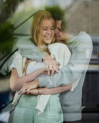 Buy stock photo Love, window and couple hug, smile and bonding for relationship, affection and bonding together. Glass, man and happy woman embrace, loving and romance with happiness, romantic or cheerful on weekend