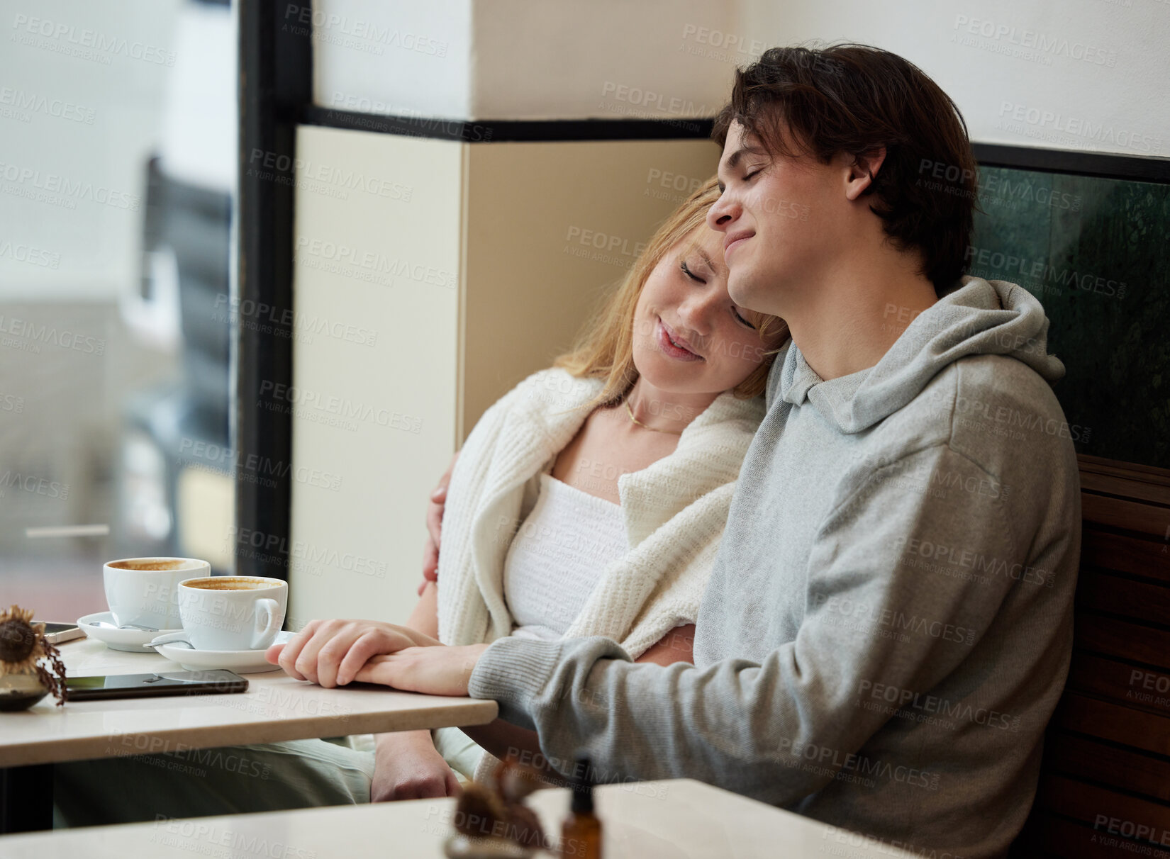 Buy stock photo Gen z, couple and coffee shop date together with love, care and hand holding in a cafe. Restaurant, relax and happiness of a teen man and girl with a happy smile from teenager relationship in morning