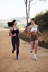 People, running and fitness women on mountain for a workout or exercise together for health and wellness happy and active. Cardio by female athletes run on a morning training outdoors in nature