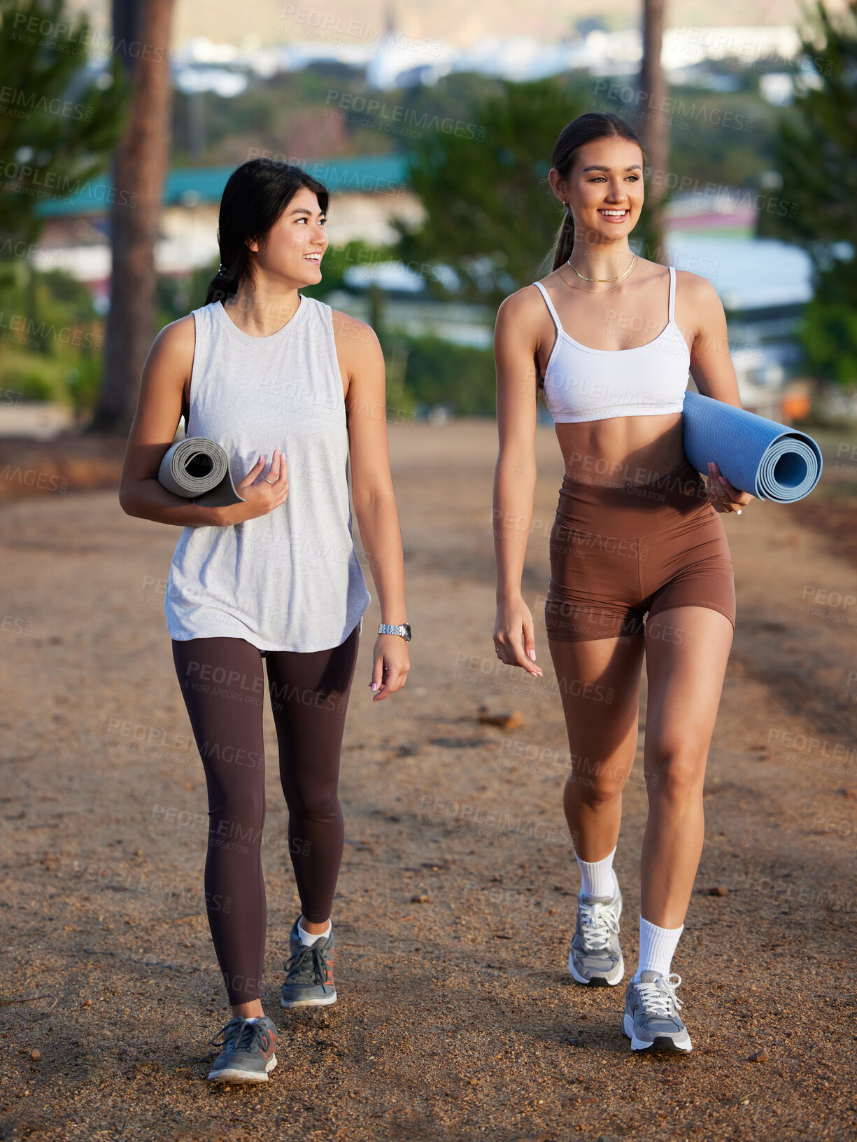 Buy stock photo Women, walking outdoor and yoga friends in nature for exercise, fitness and wellness. Young people talking in forest about workout, training and motivation for mental health, chakra and zen energy