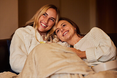 Buy stock photo Comfy, laughing and lesbian couple watching tv on the sofa, movie or subscription service. Happy, together and friends relaxing on the couch for television, a show or streaming a funny video