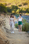 Fitness, women or walking in mountains in hiking exercise workout or trekking training in healthy lifestyle. Athlete girls, friends or happy people talking, speaking or laughing to relax in nature